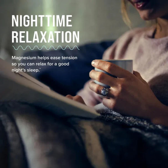 View 5 Adult woman sitting on a couch, reading a book and holding a mug, with text 'Nighttime Relaxation', 'Magnesium helps ease tension'.