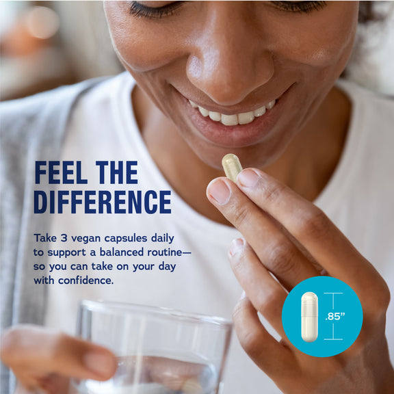 View 4 Young woman smiling, holding a vegan Magnesium Glycinate capsule and a glass of water.