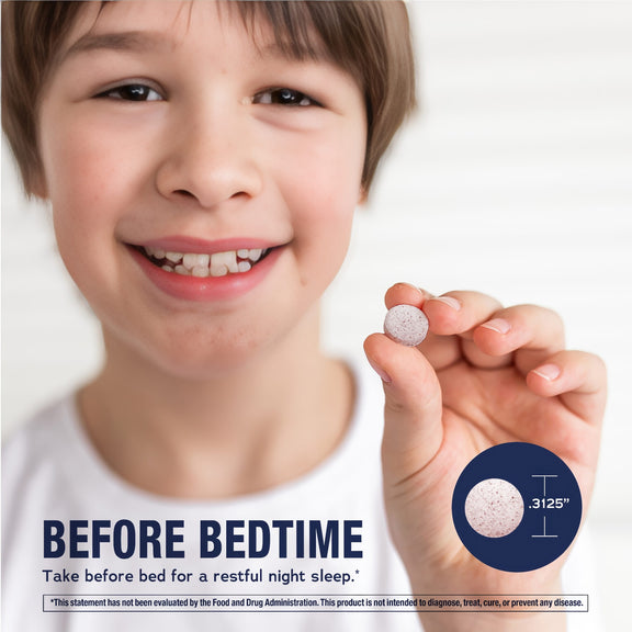 View 4 Young boy smiling, holding Kids Melatonin tablet. Inset shows tablet diameter as 0.3125 inch.