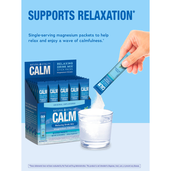 View 5 An adult hand pours a 'Calm' stick pack into a glass of water, with a box of 'Calm' stick packs visible in the background.