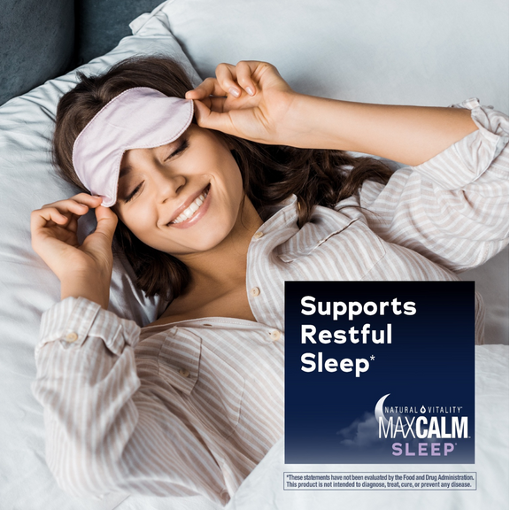 View 5 Young woman smiling in bed, adjusting a sleep mask, with MaxCalm Sleep graphic: 'Supports Restful Sleep*'.