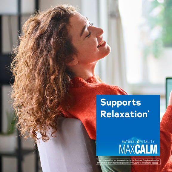 View 5 Young woman relaxing with eyes closed and a smile near a MAXCALM product box, promoting relaxation.